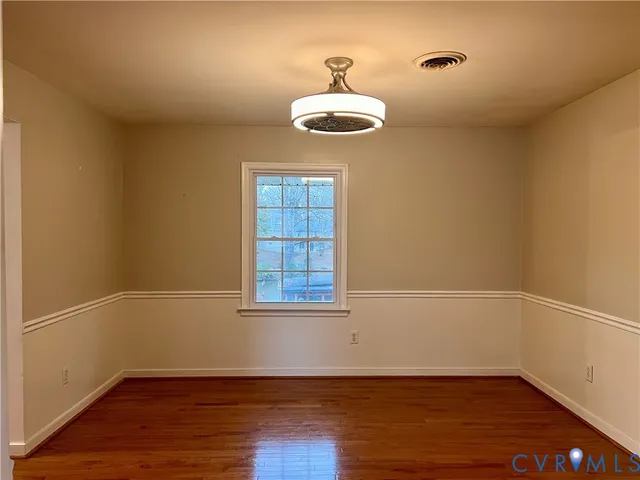 a view of kitchen with wooden floor and electronic appliances