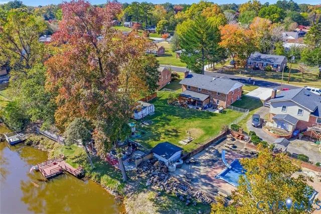 an aerial view of residential houses with outdoor space and swimming pool