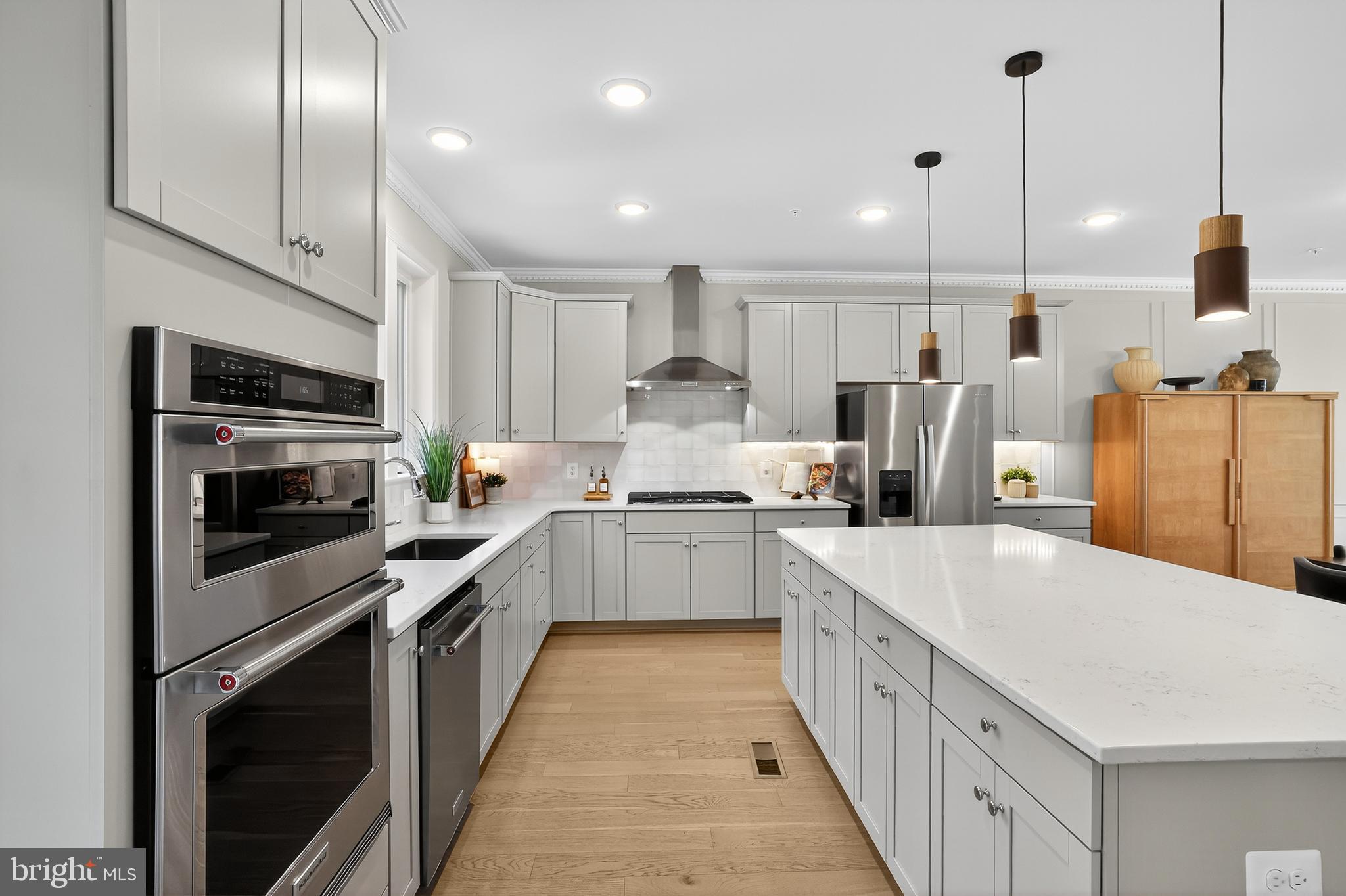 3440 Watershed Boulevard Laurel, MD 20724 - Photo 7 of 102 a large kitchen with stainless steel appliances kitchen island a large counter top a stove a sink and a refrigerator