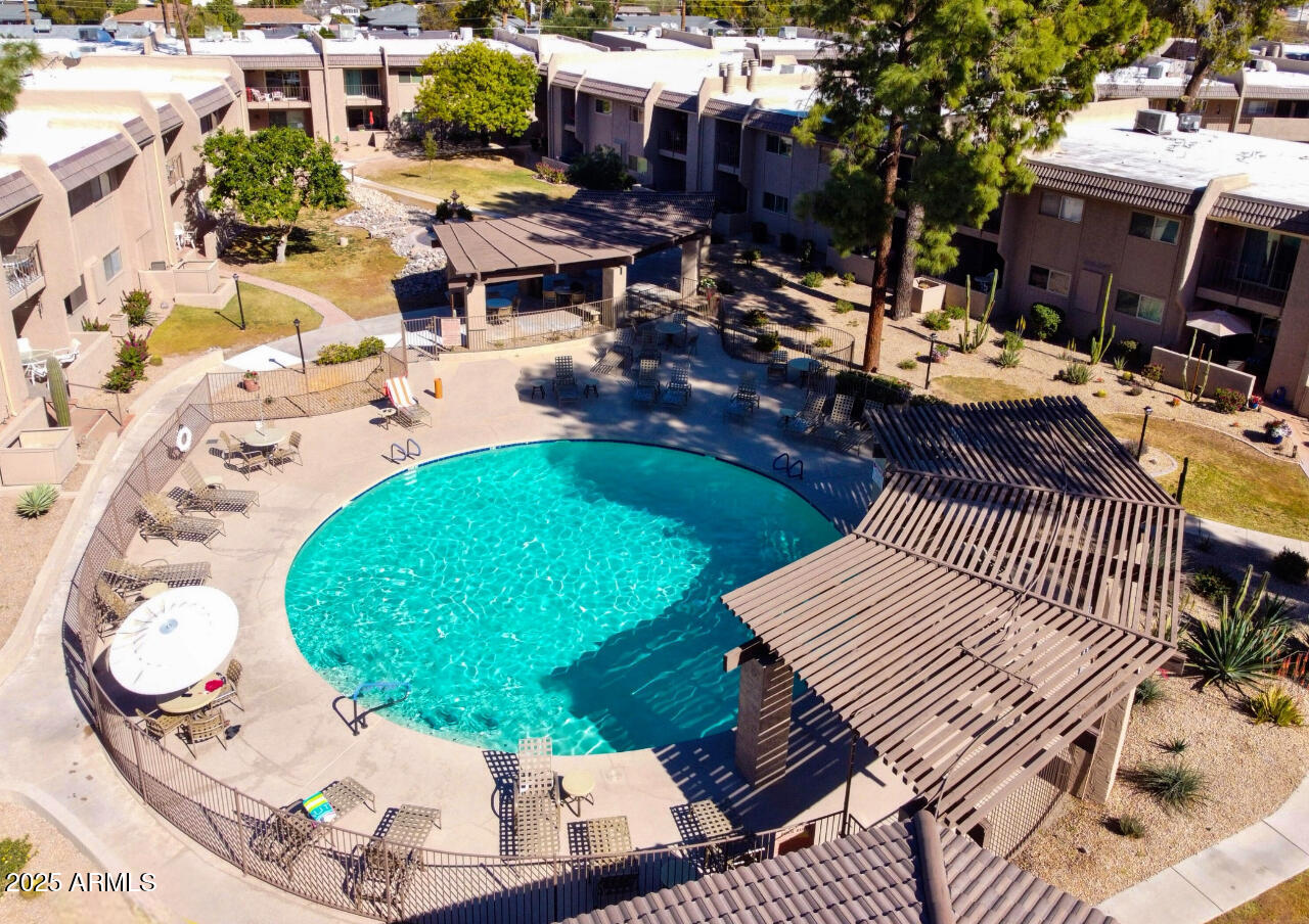 7436 East Chaparral Road, Unit 264B Scottsdale, AZ 85250 - Photo 12 of 22 an aerial view of a swimming pool with outdoor seating