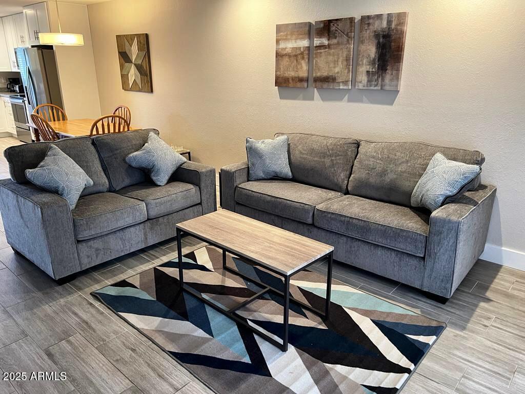 7436 East Chaparral Road, Unit 264B Scottsdale, AZ 85250 - Photo 4 of 22 a living room with furniture and a rug