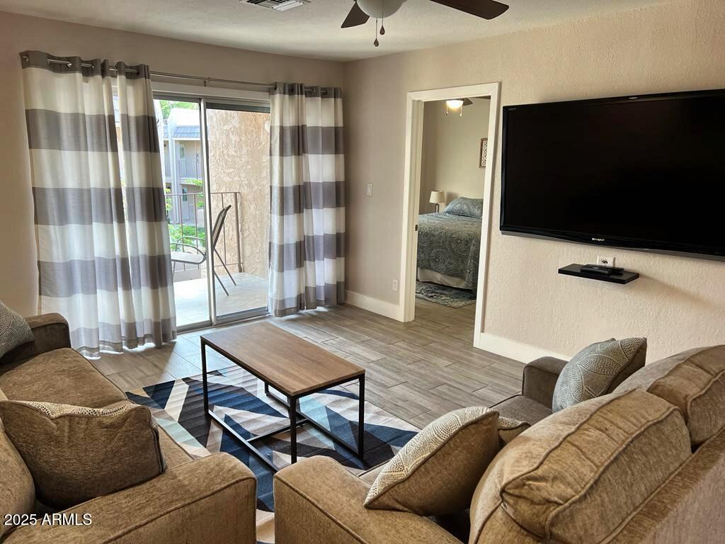 7436 East Chaparral Road, Unit 264B Scottsdale, AZ 85250 - Photo 5 of 22 a living room with furniture and a flat screen tv
