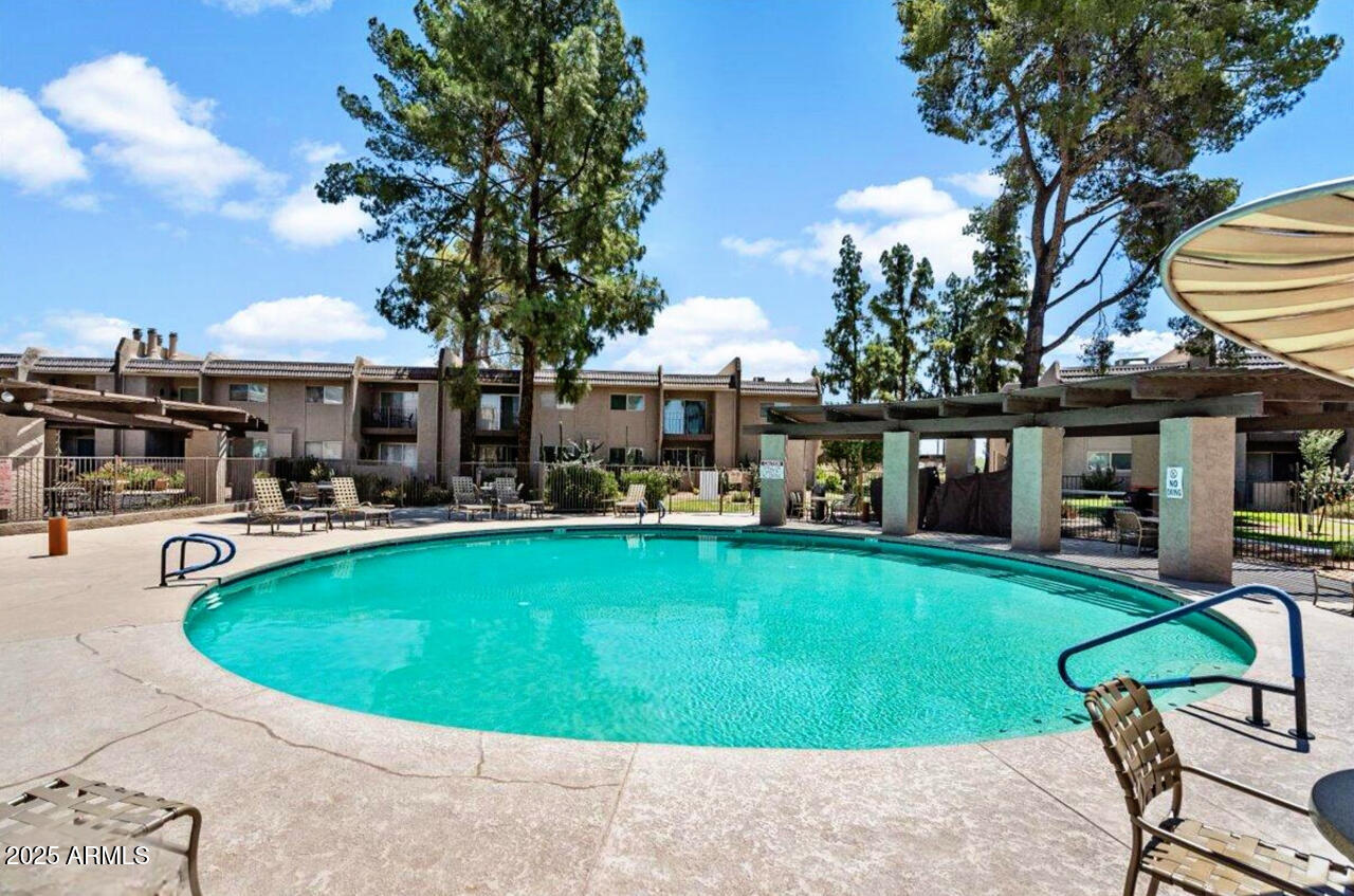 7436 East Chaparral Road, Unit 264B Scottsdale, AZ 85250 - Photo 6 of 22 a view of a house with swimming pool and sitting area