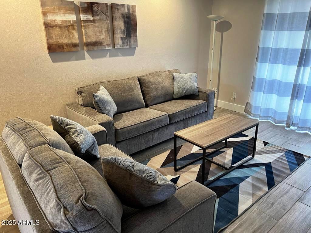 7436 East Chaparral Road, Unit 264B Scottsdale, AZ 85250 - Photo 7 of 22 a living room with furniture and a wooden floor