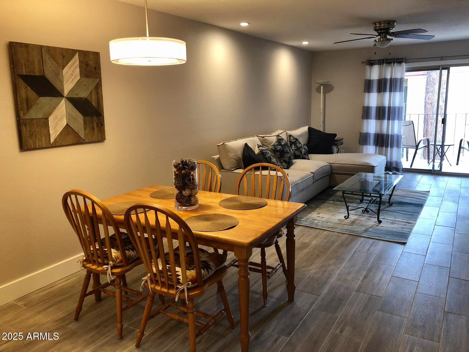 7436 East Chaparral Road, Unit 264B Scottsdale, AZ 85250 - Photo 8 of 22 a view of a dining room with furniture wooden floor and chandelier