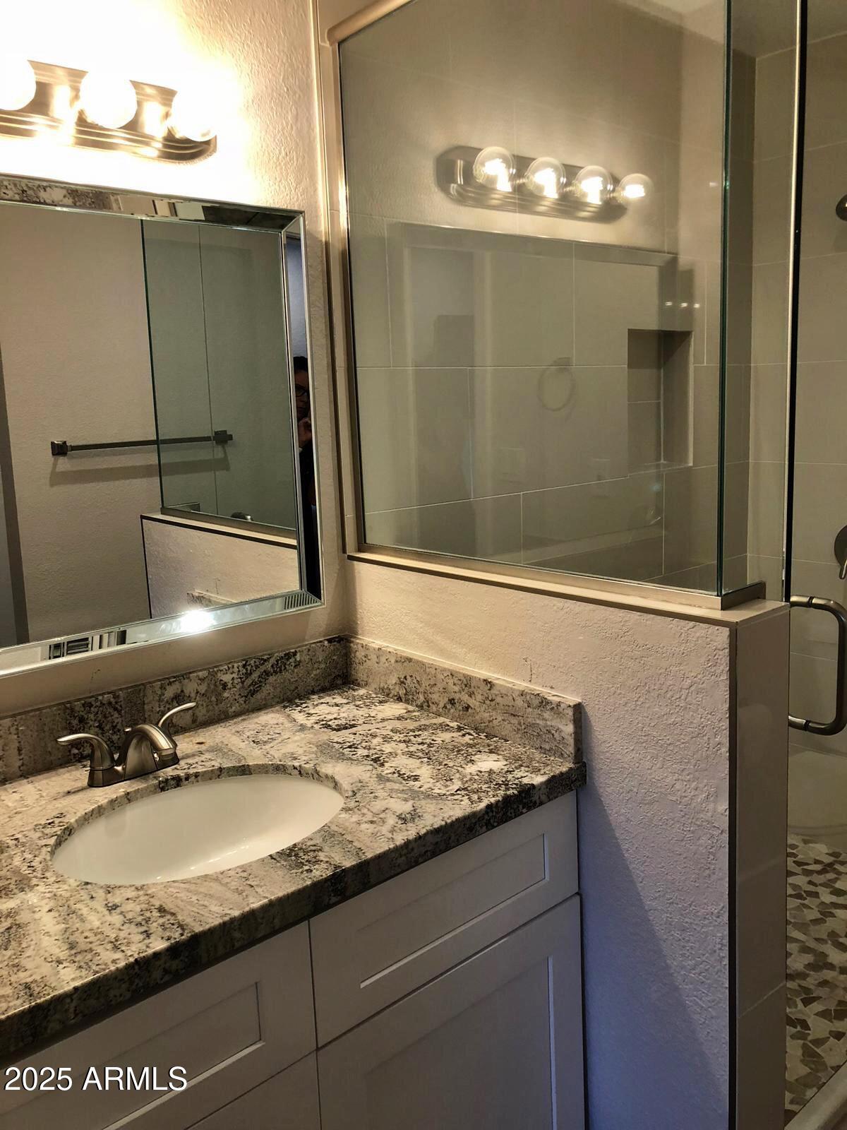 7436 East Chaparral Road, Unit 264B Scottsdale, AZ 85250 - Photo 10 of 22 a bathroom with a granite countertop sink and mirror