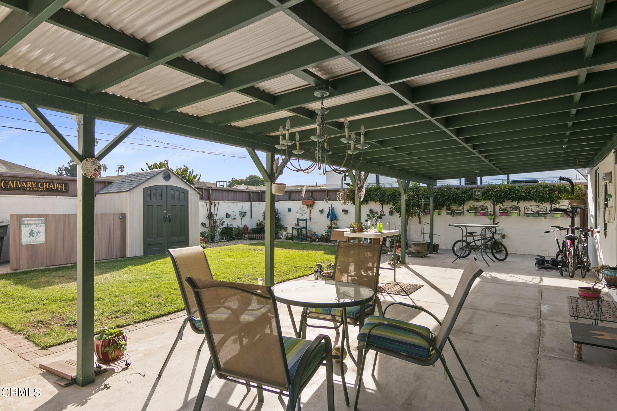 524 Nectarine Street Oxnard, CA 93033 - Photo 21 of 28 a view of a patio with table and chairs under an umbrella with a small yard