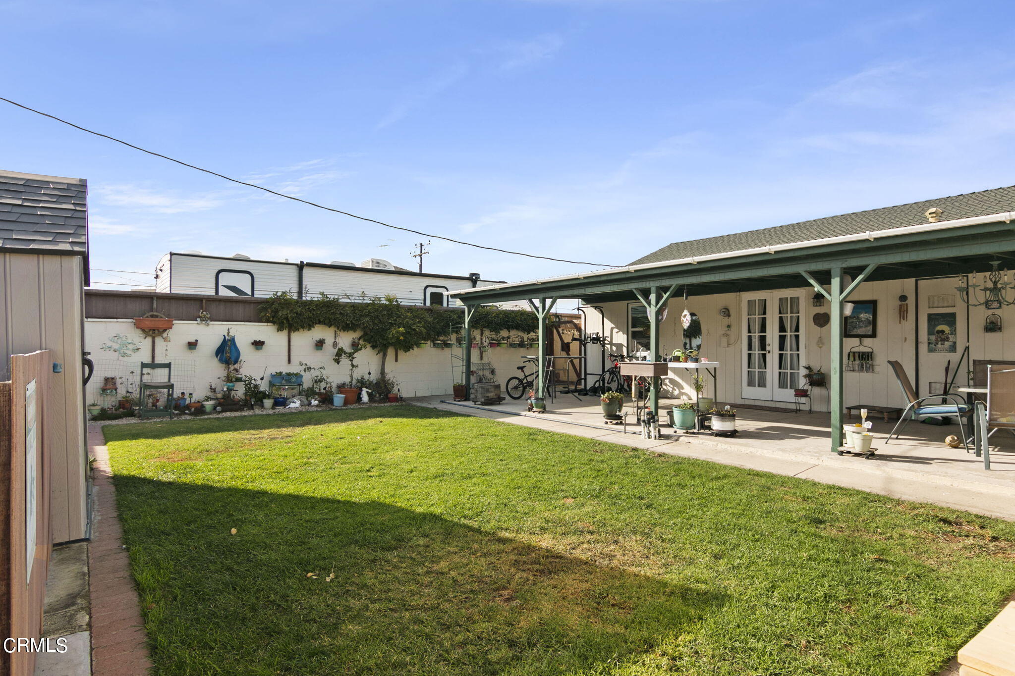 524 Nectarine Street Oxnard, CA 93033 - Photo 23 of 28 a view of a patio with table and chairs under an umbrella