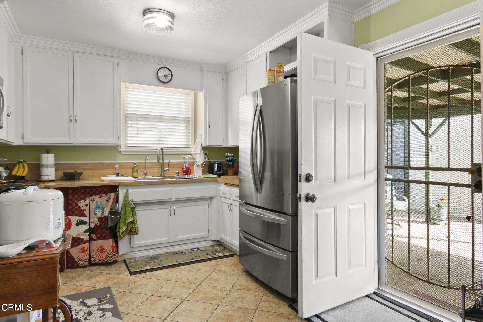524 Nectarine Street Oxnard, CA 93033 - Photo 8 of 28 a kitchen with a refrigerator and white cabinets