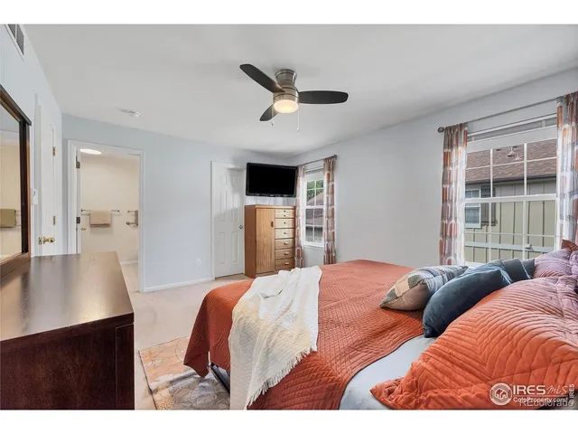 a bedroom with a large bed and a large window