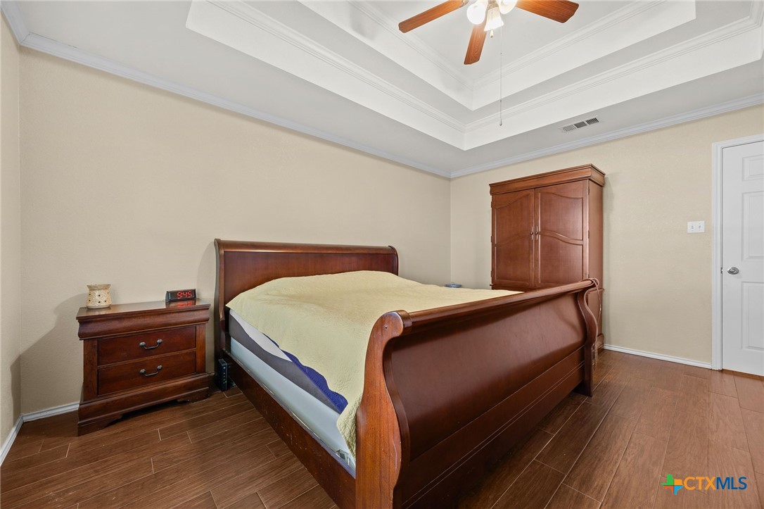 910 Neuberry Cliffe Temple, TX 76502 - Photo 15 of 32 a bedroom with a bed and a chandelier