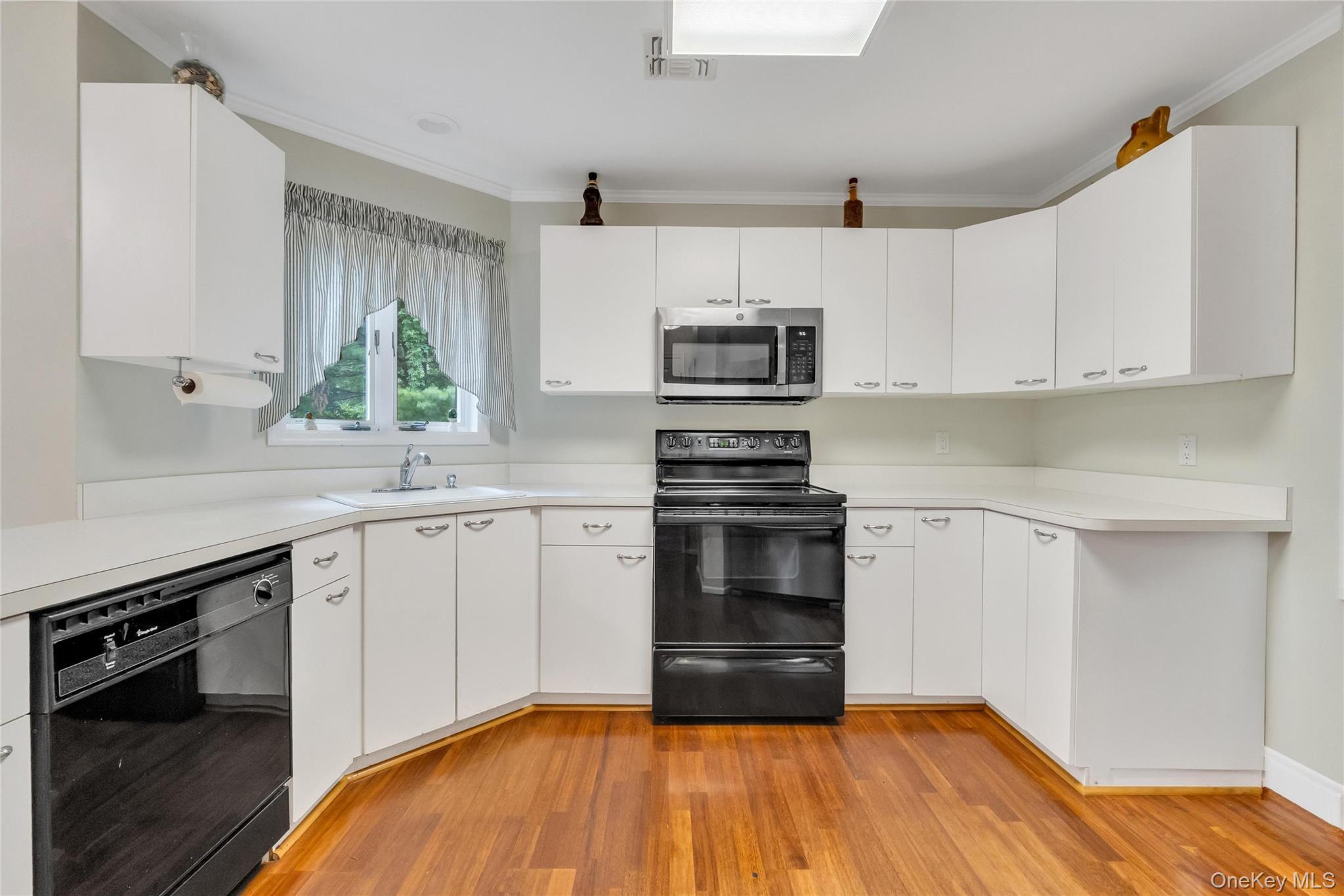 22 Kettle Hole Road Manorville, NY 11949 - Photo 10 of 39 Eat in Kitchen -Formica cabinets and countertop. Hardwood floors