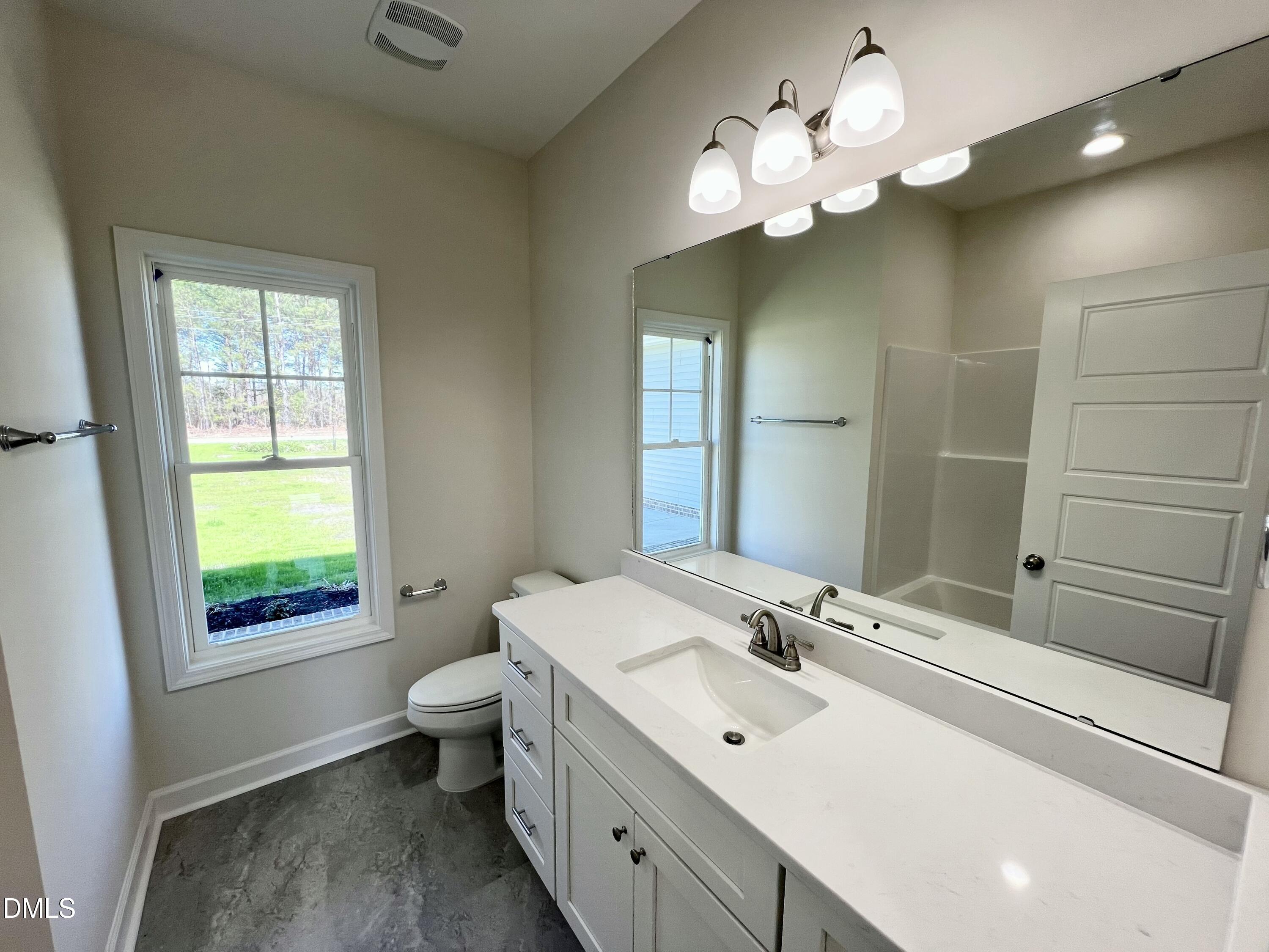 731 Polly Watson Road Fremont, NC 27830 - Photo 16 of 21 a bathroom with a sink vanity mirror and toilet