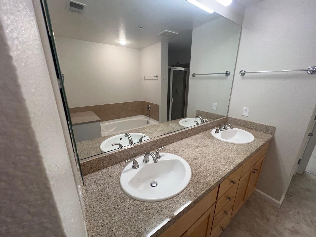800 North 8th Street, Unit 120 San Jose, CA 95112 - Photo 11 of 21 a bathroom with a sink a mirror and a sink