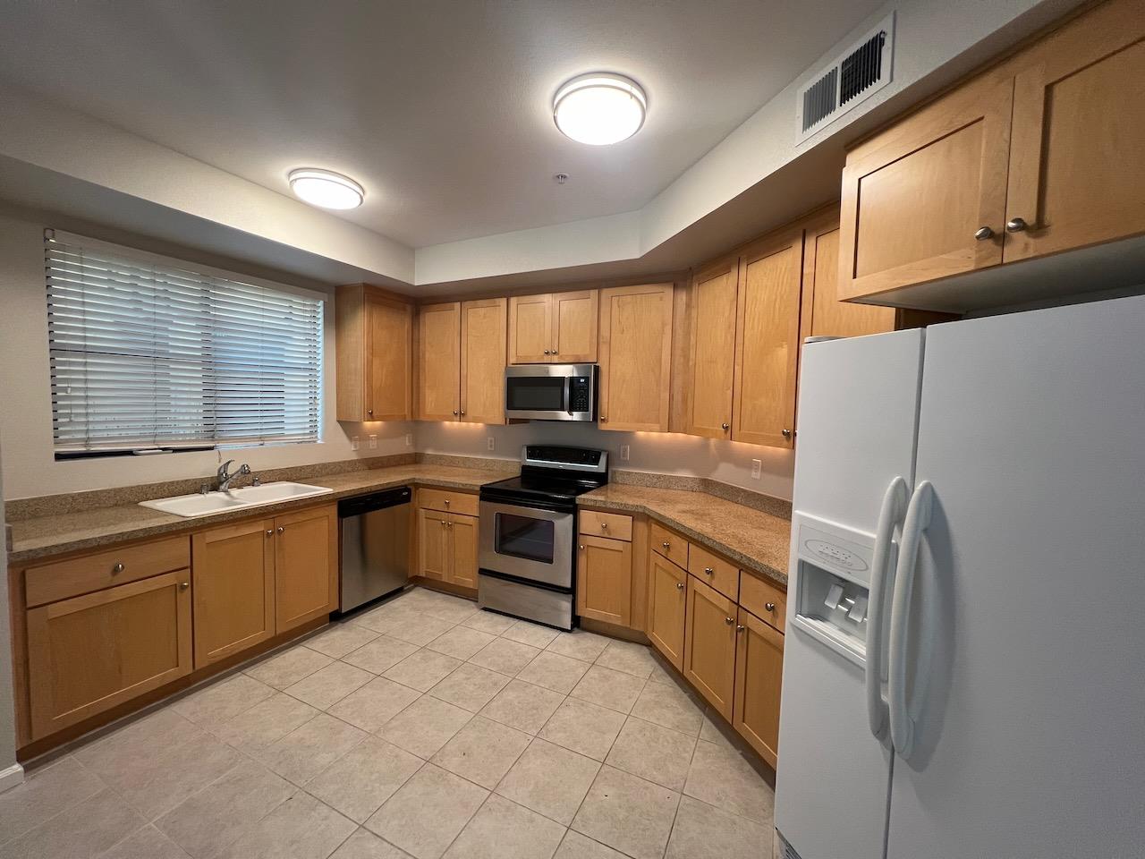 800 North 8th Street, Unit 120 San Jose, CA 95112 - Photo 4 of 21 a kitchen with granite countertop stainless steel appliances a refrigerator sink and microwave