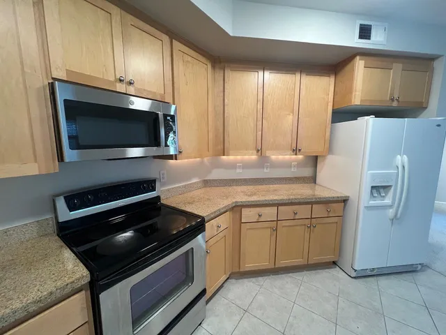 a kitchen with a stove microwave and refrigerator