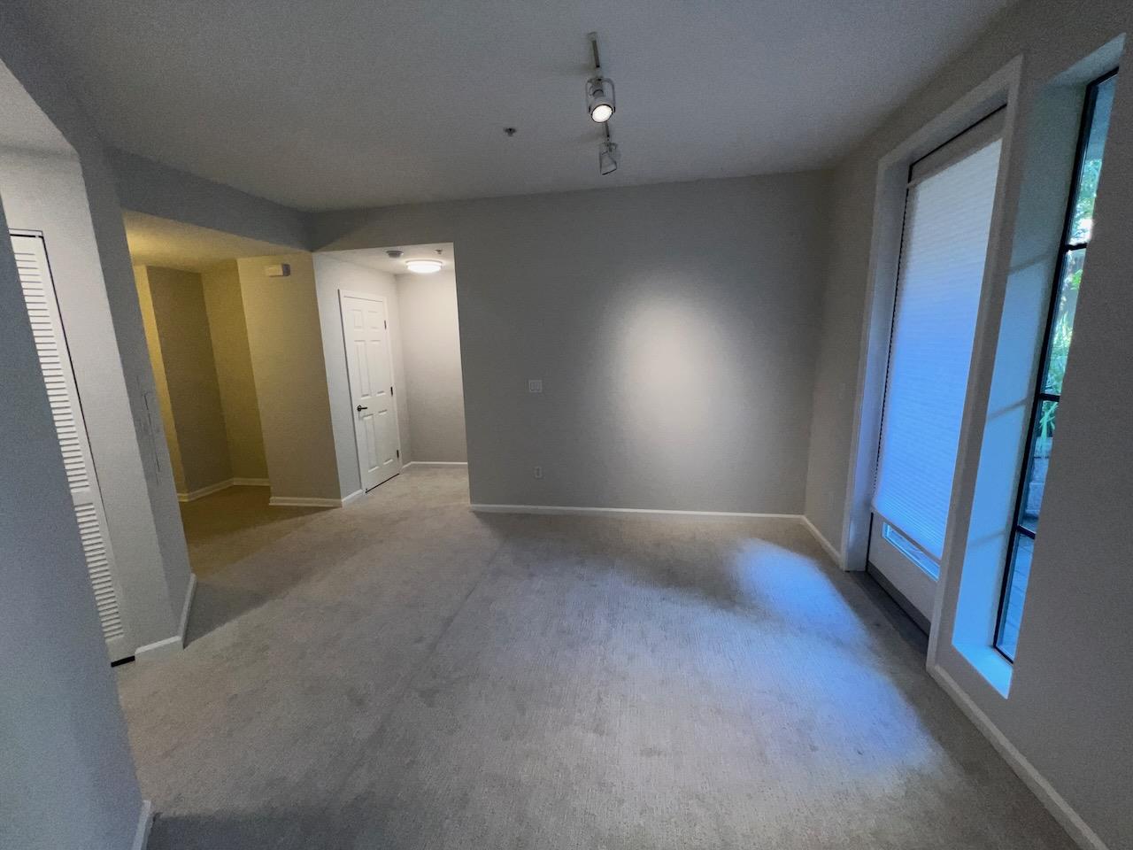 800 North 8th Street, Unit 120 San Jose, CA 95112 - Photo 8 of 21 an empty room with windows and a chandelier fan