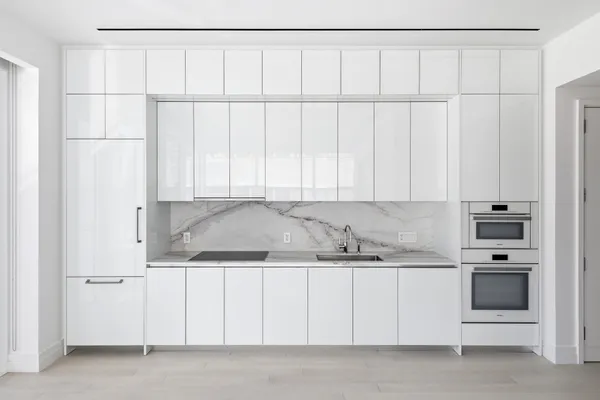 a dining room with furniture and large windows