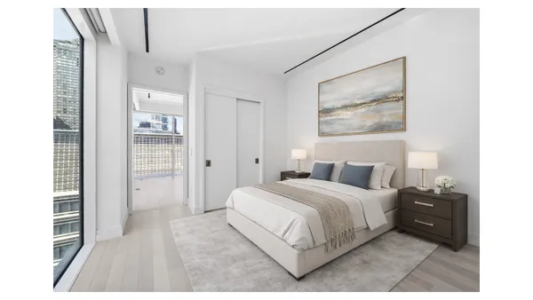 a bedroom with a bed and a painting on the wall