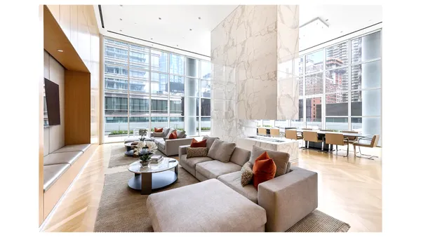 a living room with furniture and large windows