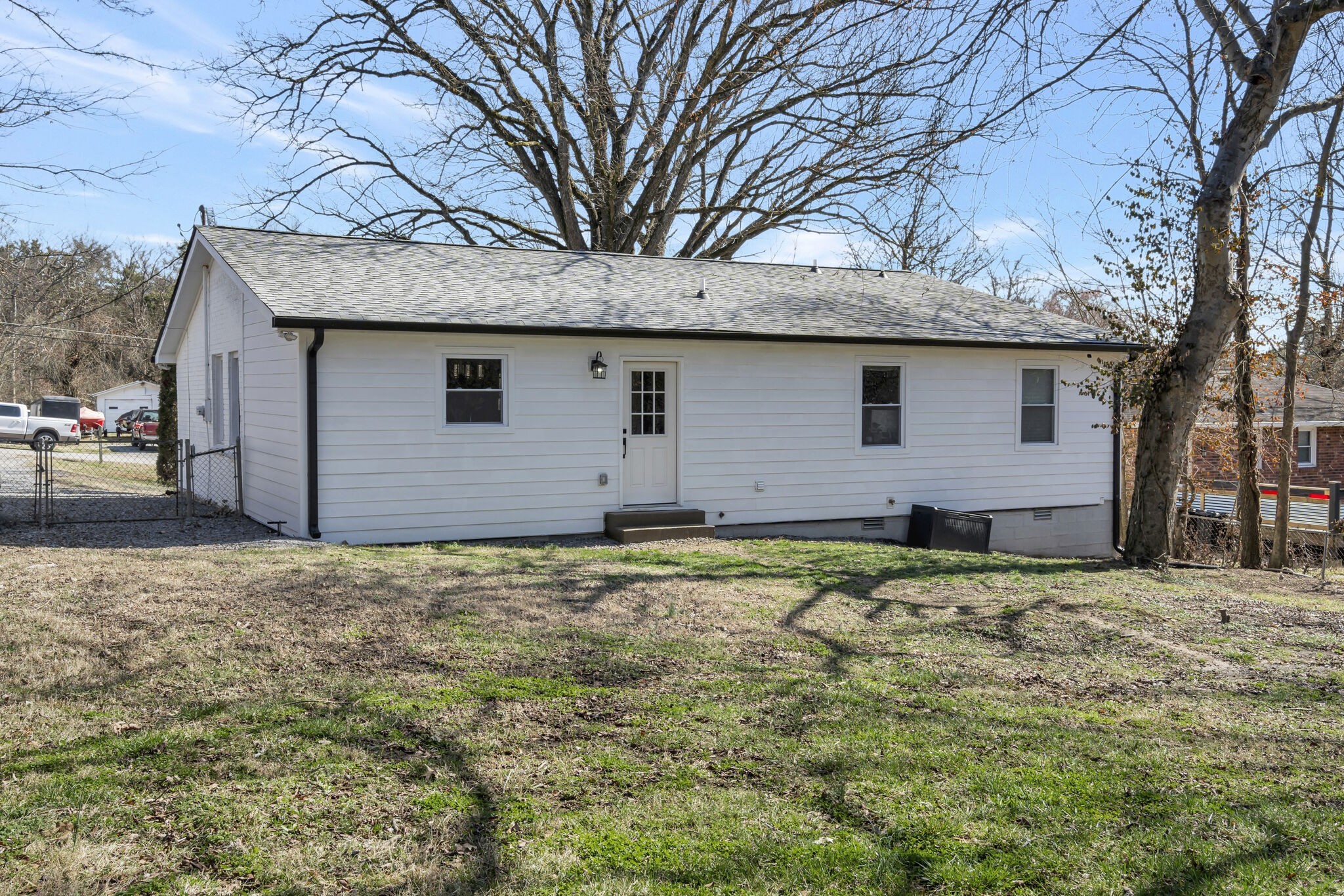 114 River Road Hendersonville, TN 37075 - Photo 22 of 34 a backyard of a house with large trees and brick wall