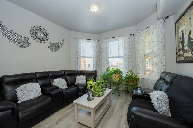 a living room with furniture and a potted plant