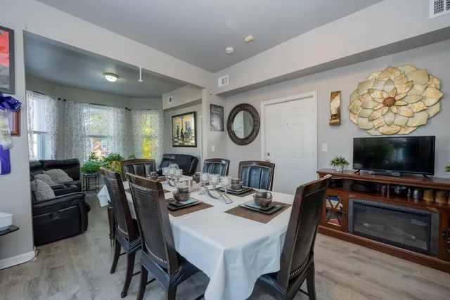a view of a dining room with furniture and wooden floor