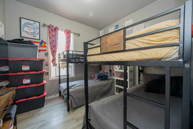 a bed sitting in a bedroom next to a window