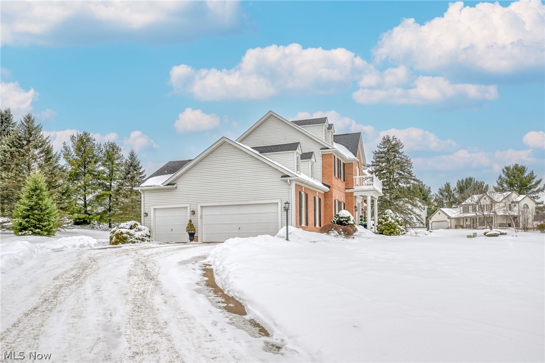 3912 Raintree Circle Uniontown, OH 44685 - Photo 35 of 49 Snow covered driveway with a garage and brick & vinyl siding