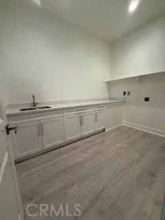 a view of a kitchen with cabinets and wooden floor