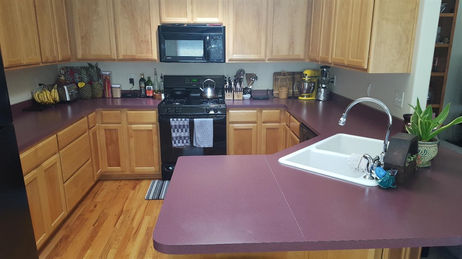 15 Logan Way Talent, OR 97540 - Photo 6 of 9 a kitchen with stainless steel appliances granite countertop a coffee maker a sink a counter space and cabinets