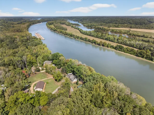 a front view of a house with a garden and trees