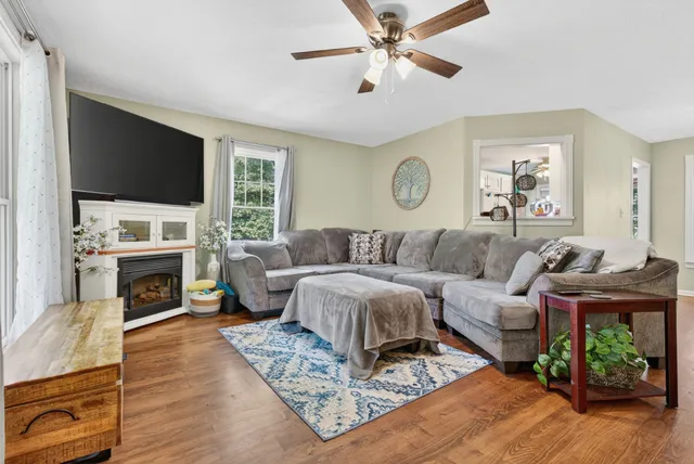a living room with furniture fireplace and a flat screen tv