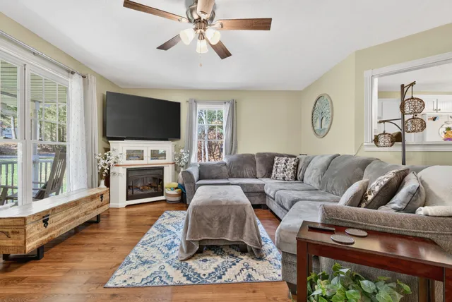 a living room with furniture and wooden floor
