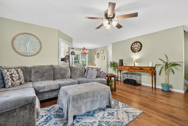 a view of a dining room with furniture and chandelier