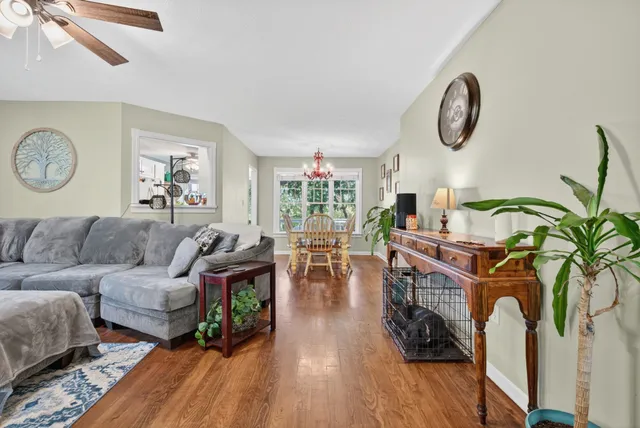 a view of a dining room with furniture wooden floor and chandelier