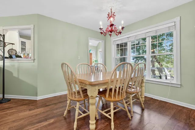 a view of a kitchen with wooden floor and a window