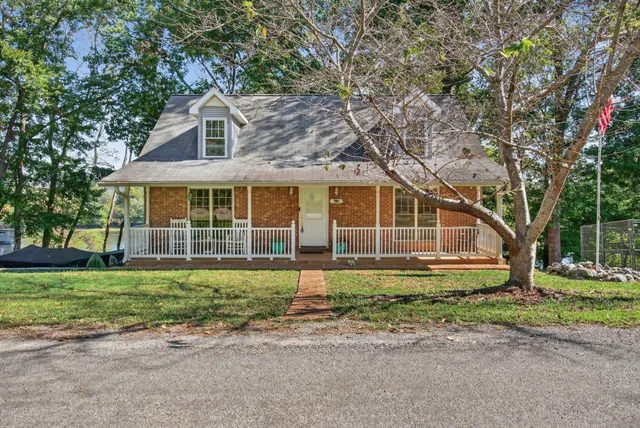 a view of a house with a yard and sitting area