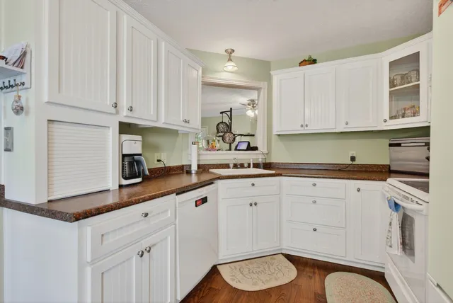 a bathroom with a double vanity sink a mirror and a bathtub
