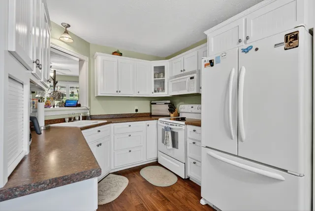 a bathroom with a sink a toilet and a window