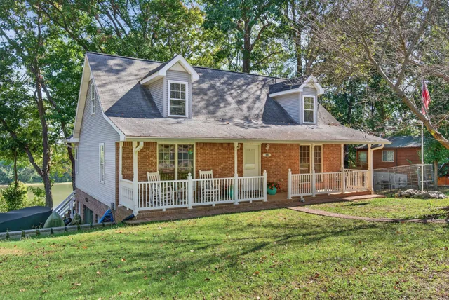 a front view of a house with a yard table and chairs