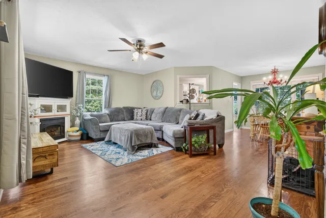 a living room with furniture fireplace and a flat screen tv