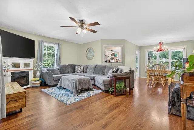 a living room with furniture a fireplace and a flat screen tv