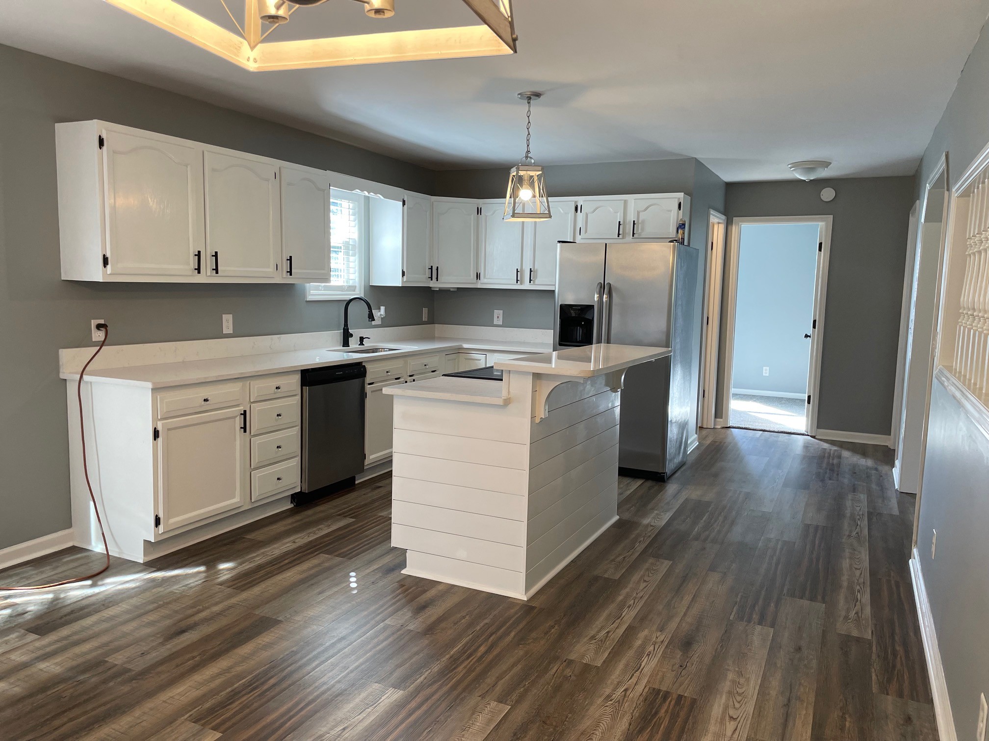 295 Brown Road Morrison, TN 37357 - Photo 17 of 29 a kitchen with a white cabinets stainless steel appliances and wooden floor