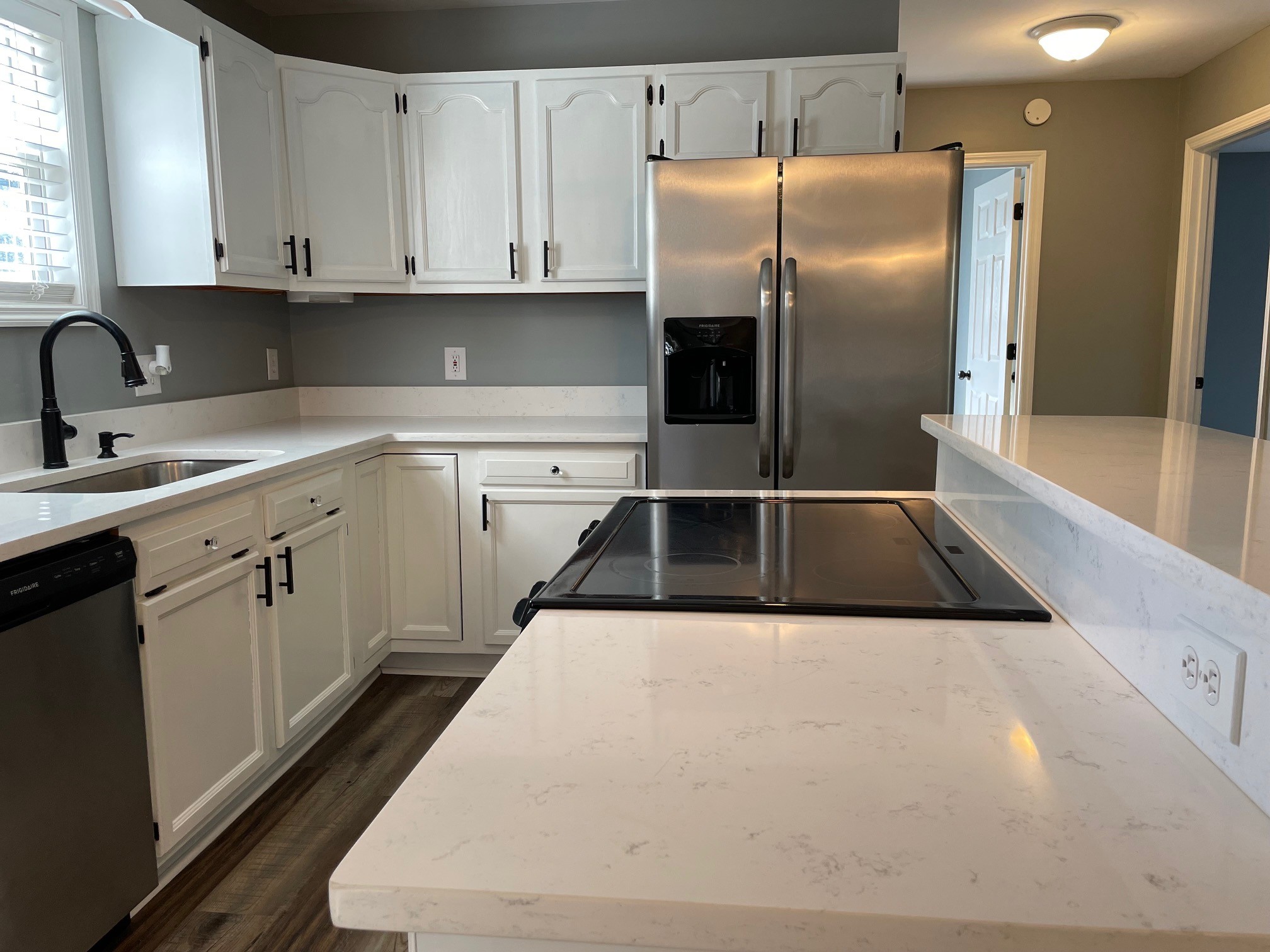 295 Brown Road Morrison, TN 37357 - Photo 19 of 29 a kitchen with stainless steel appliances kitchen island granite countertop a sink a refrigerator and white cabinets
