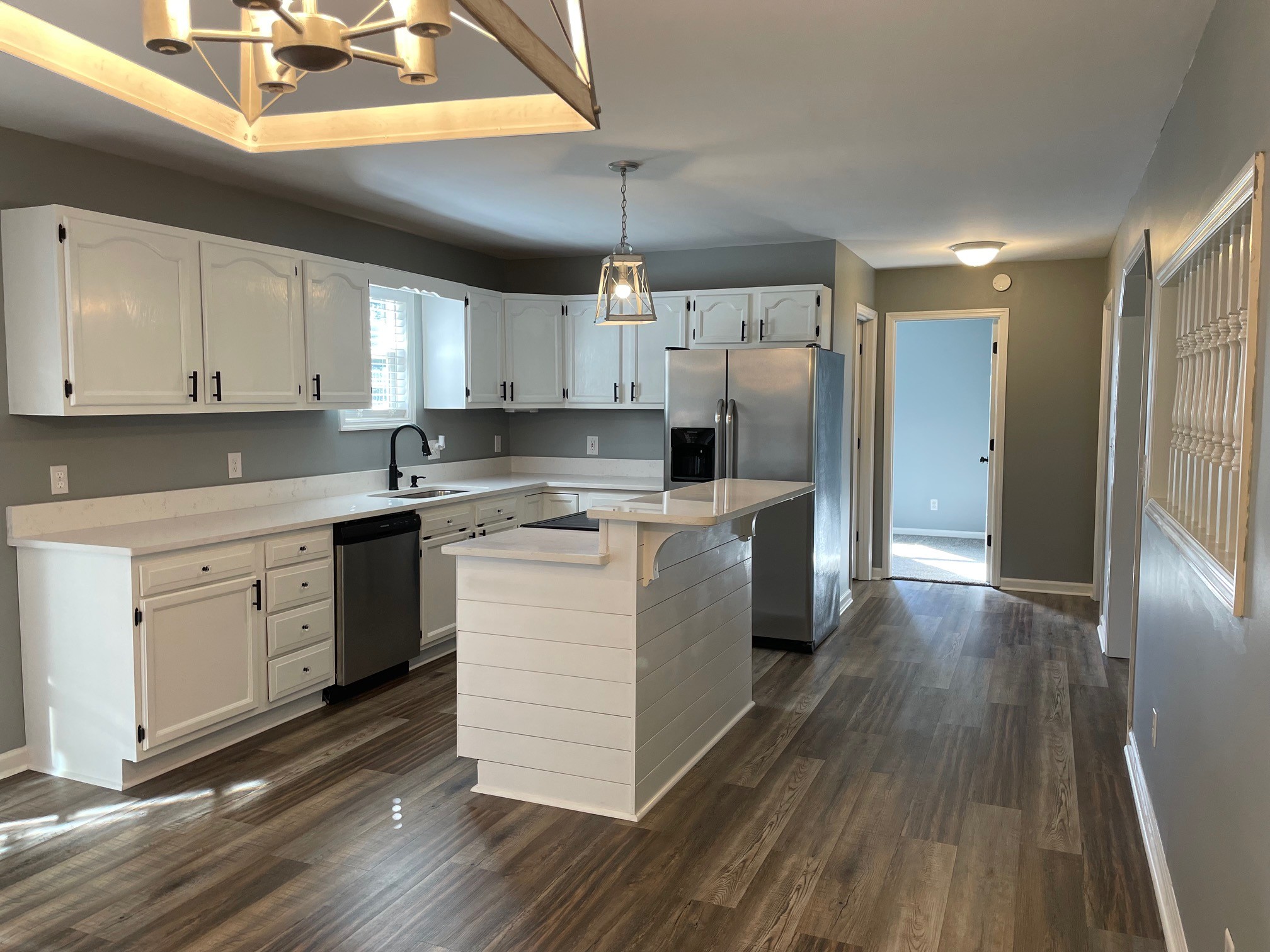 295 Brown Road Morrison, TN 37357 - Photo 24 of 29 a kitchen with stainless steel appliances granite countertop a refrigerator a sink dishwasher a stove and white countertops with wooden floor