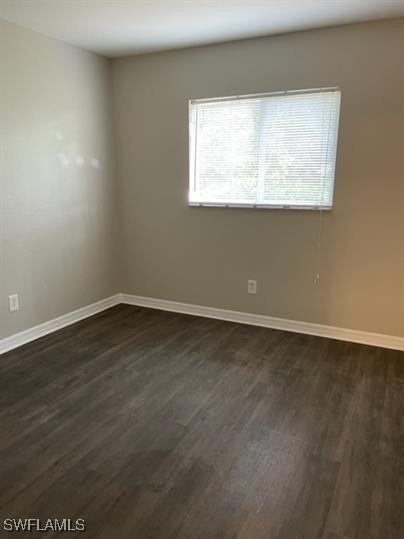 111 East 12th Street Lehigh Acres, FL 33972 - Photo 11 of 17 an empty room with wooden floor and a window