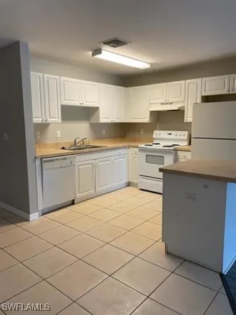 a view of a kitchen with a sink and cabinets