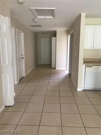 an empty room with wooden floor and a window