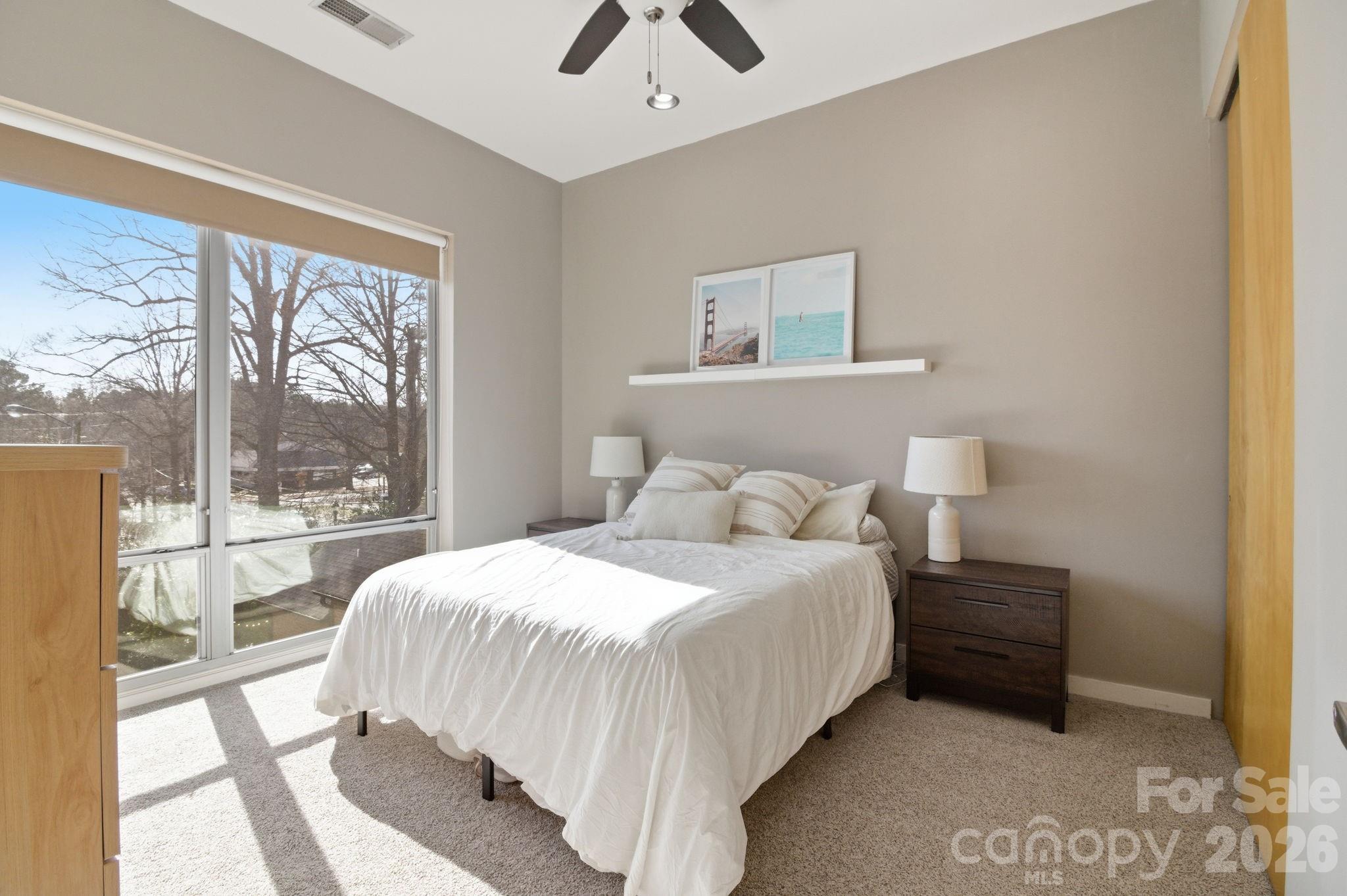 2116 McClintock Road, Unit 123 Charlotte, NC 28205 - Photo 11 of 28 a bedroom with a bed and a large window